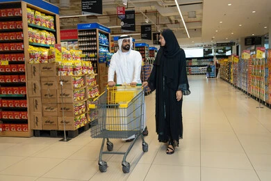 زوجان إماراتيان يتسوقان في ممر السوبر ماركت