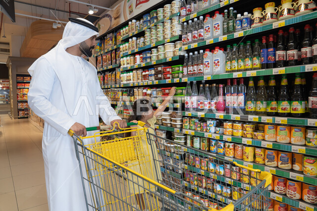 Emirati Man and Daughter Shopping in Supermarket