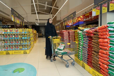 Arab Woman Shopping at Saudi Hypermarket with Cart