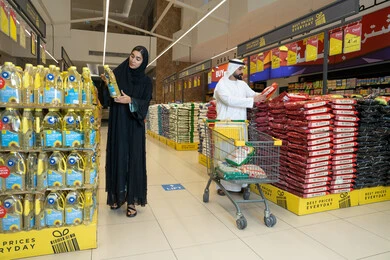 Emirati Couple Grocery Shopping in a Modern Supermarket