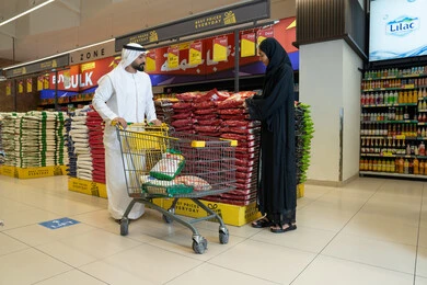 Emirati Couple Shopping for Food in a Modern Supermarket
