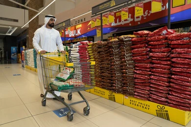 Emirati Man Shopping at Hypermarket with Cart