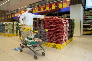 Emirati Man Shopping in Supermarket with Trolley