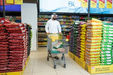 Emirati Man Shopping in Supermarket with Trolley