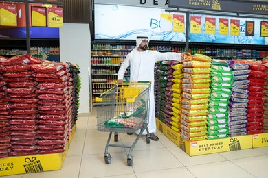 Emirati Man Shopping for Rice Bags in Supermarket Aisle