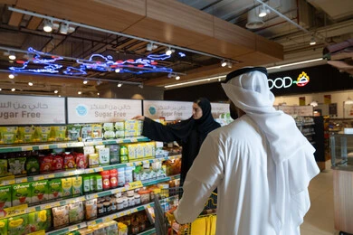 Emirati Couple Shopping in Supermarket Sugar Free Aisle