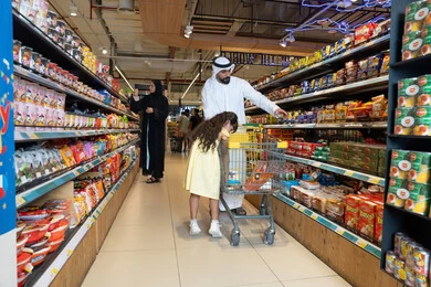 Emirati Family Shopping in Supermarket Grocery Aisle