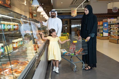 Emirati Family Shopping at Supermarket Deli Counter