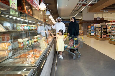 Emirati Family Shopping at Supermarket Food Counter