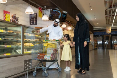 Emirati Family Shopping at Supermarket Bakery
