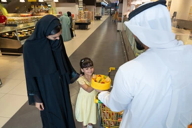 Emirati Family Shopping in Supermarket Bakery Section