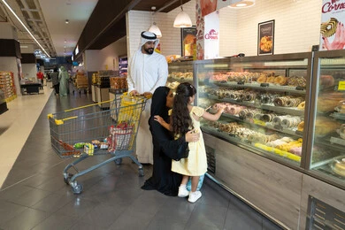 Emirati Family Shopping at Supermarket Bakery Counter