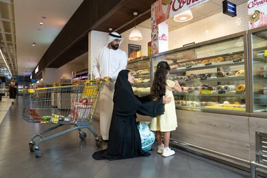 Emirati Family Shopping at Supermarket Bakery Section