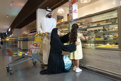Emirati Family Shopping in Supermarket Bakery Section