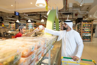Emirati Man Shopping at Hypermarket Deli Section