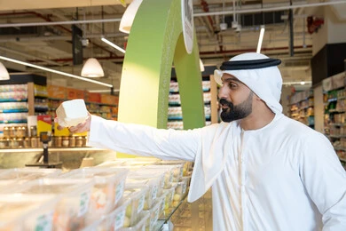 Emirati Man Shopping for Food in Modern Supermarket