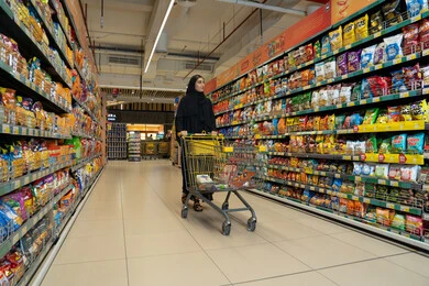 Emirati Woman Shopping in Modern Supermarket Aisle