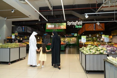 Emirati Family Shopping at Springfield Market Produce Section
