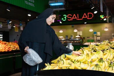 Emirati Woman Shopping Bananas in UAE Supermarket