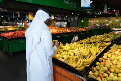 Emirati Man Buying Fresh Fruit in Supermarket
