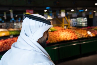 Emirati Man in Supermarket Produce Section