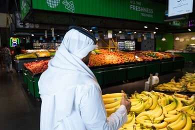Emirati Man Shopping for Fresh Fruits in Supermarket