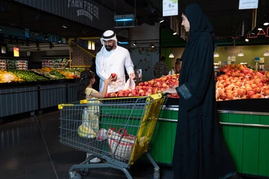 Emirati Family Shopping for Fresh Fruit in Supermarket