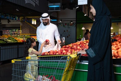 Emirati Family Shopping For Produce in Supermarket
