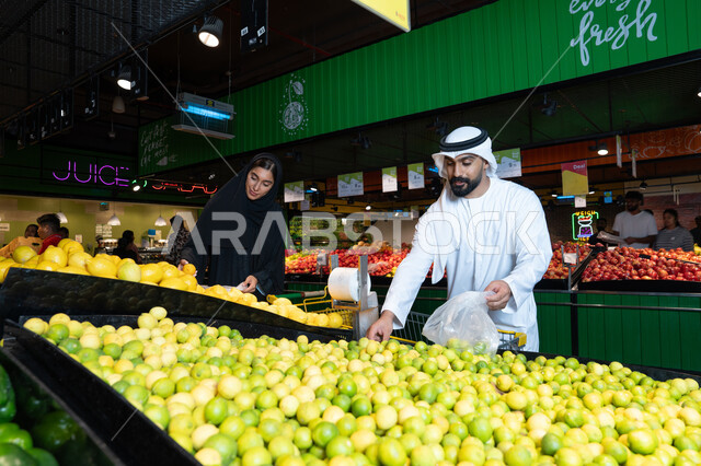 Emirati Couple Shopping for Fresh Produce in Supermarket