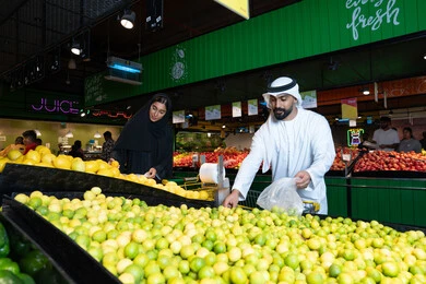 Emirati Couple Shopping for Fresh Produce in Supermarket