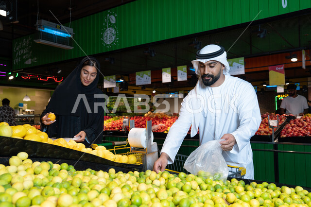 Emirati Couple Shopping for Fresh Fruit in Supermarket