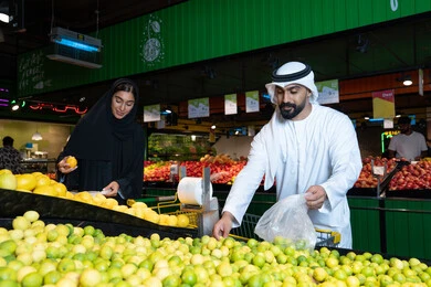 Emirati Couple Shopping for Fresh Fruit in Supermarket