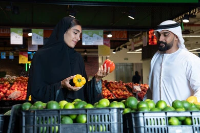 Emirati Couple Shopping for Fresh Vegetables in Supermarket