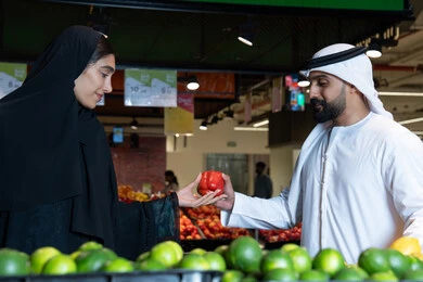 Emirati Man and Woman Shopping for Produce in UAE