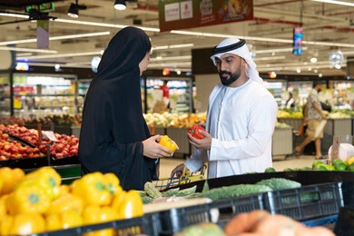 Emirati Couple Shopping for Vegetables in Supermarket