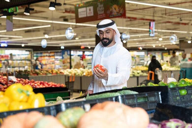 Emirati Man Shopping for Fresh Vegetables in Supermarket