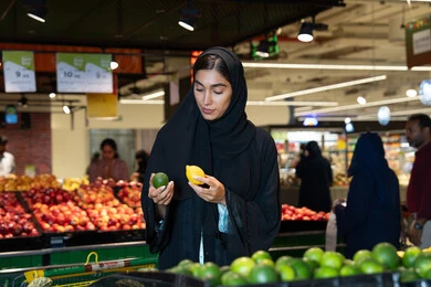 Emirati Woman Shopping for Fresh Fruits in Supermarket