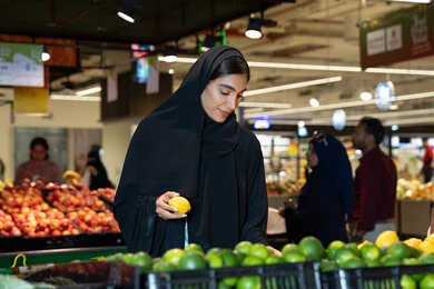 Emirati Woman Shopping for Fresh Fruit in Supermarket
