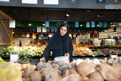 Emirati Woman Shopping for Fresh Vegetables in Supermarket