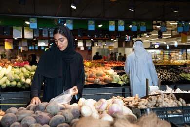 Emirati Woman Shopping for Fresh Produce in UAE