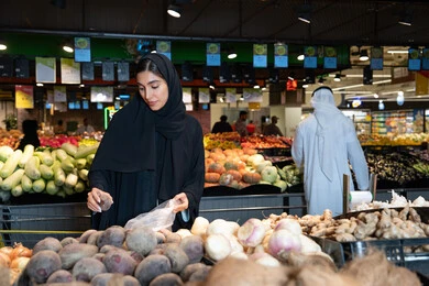 Emirati Woman Shopping for Fresh Vegetables in Supermarket