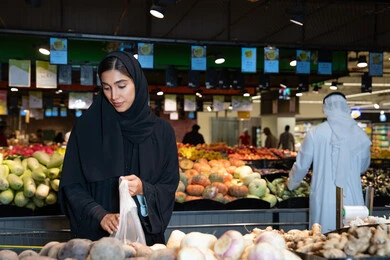 Emirati Woman Shopping for Vegetables in Supermarket