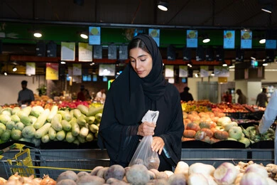 Emirati Woman Shopping for Fresh Vegetables in Supermarket