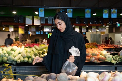 Emirati Woman Shopping for Fresh Vegetables in Supermarket