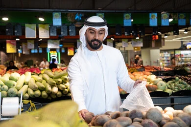 Emirati Man Shopping for Fresh Vegetables in Supermarket