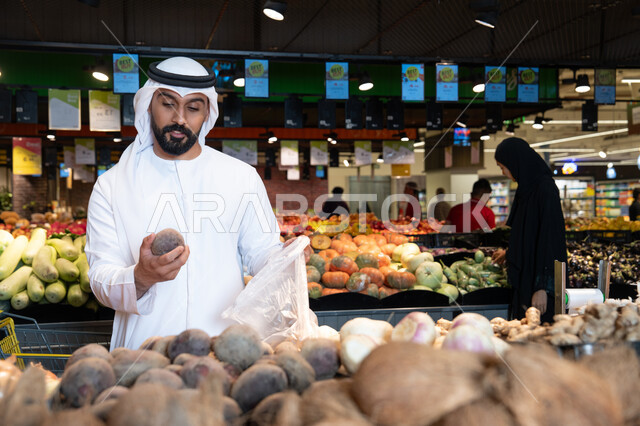Emirati Man Shopping for Fresh Vegetables in Supermarket