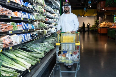 Emirati Man Shopping for Vegetables in Supermarket