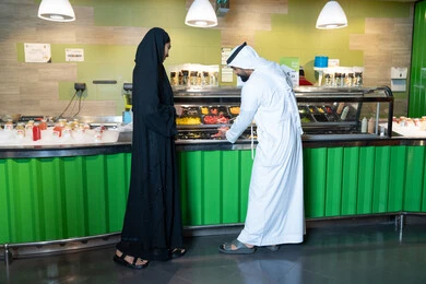 Emirati Couple at Fresh Food Counter in UAE