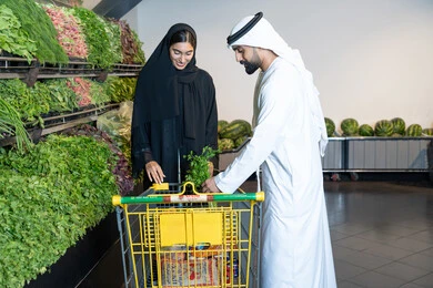 Emirati Couple Shopping for Fresh Vegetables in Supermarket