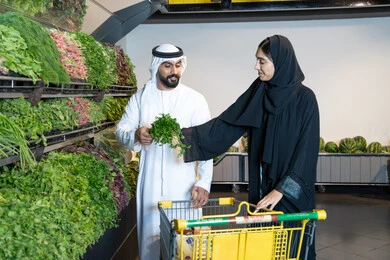 Emirati Couple Shopping for Fresh Produce in Supermarket